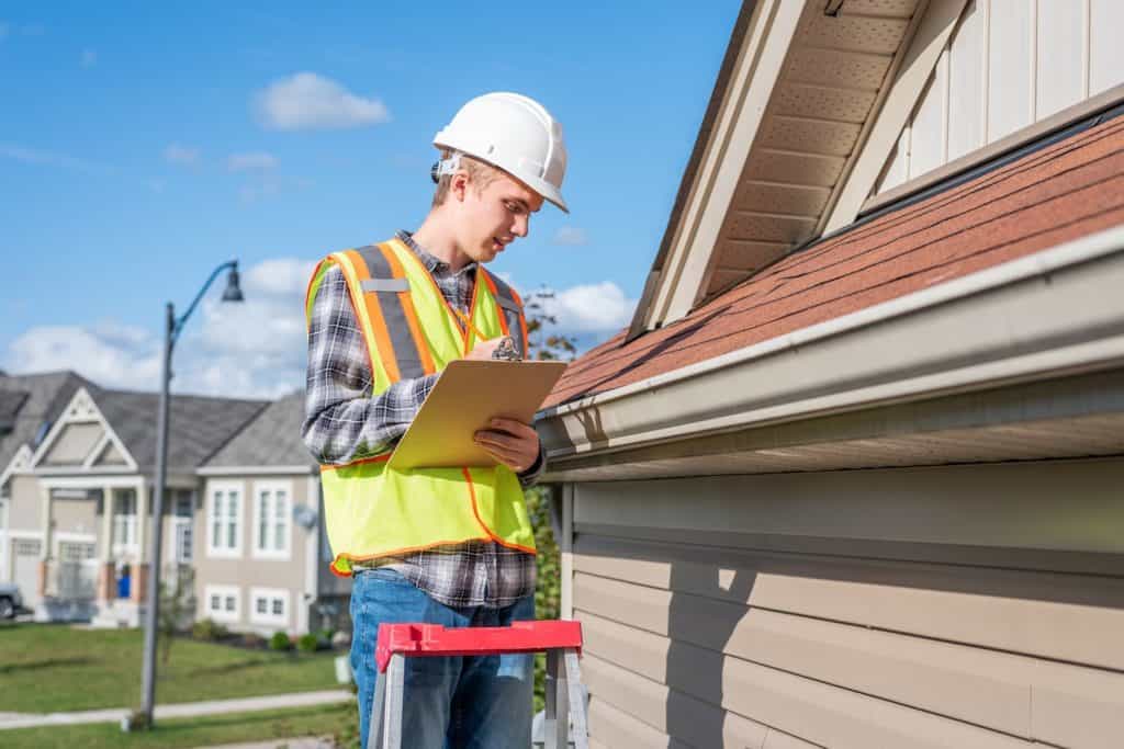 get insurance to pay for roof replacement contractor performing roof inspection