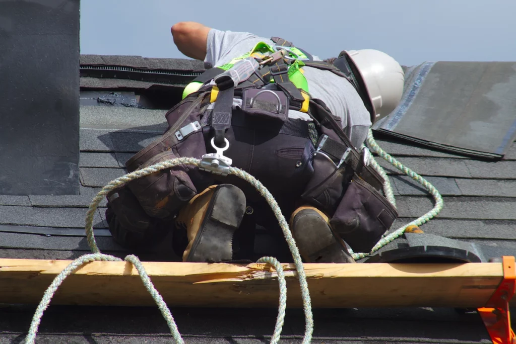 roofer finding and fixing hail damage