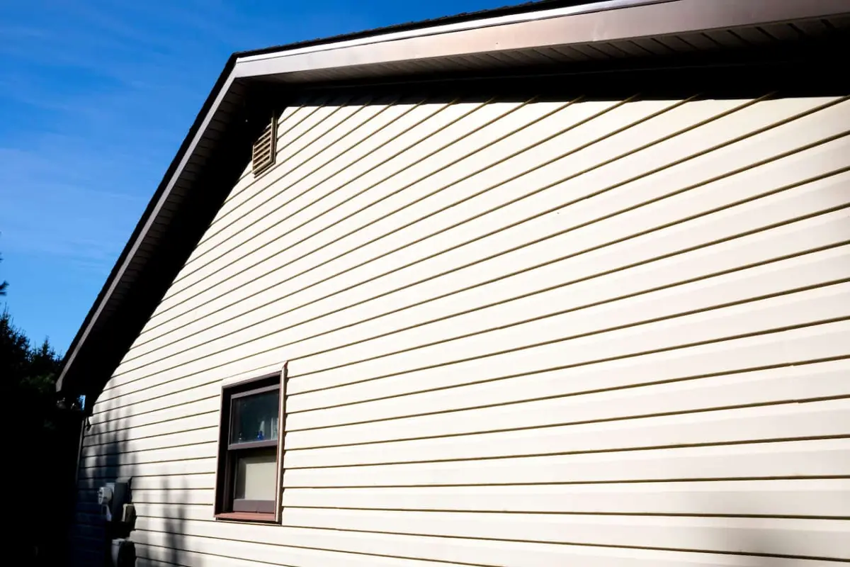 side view of cream vinyl siding in the sun