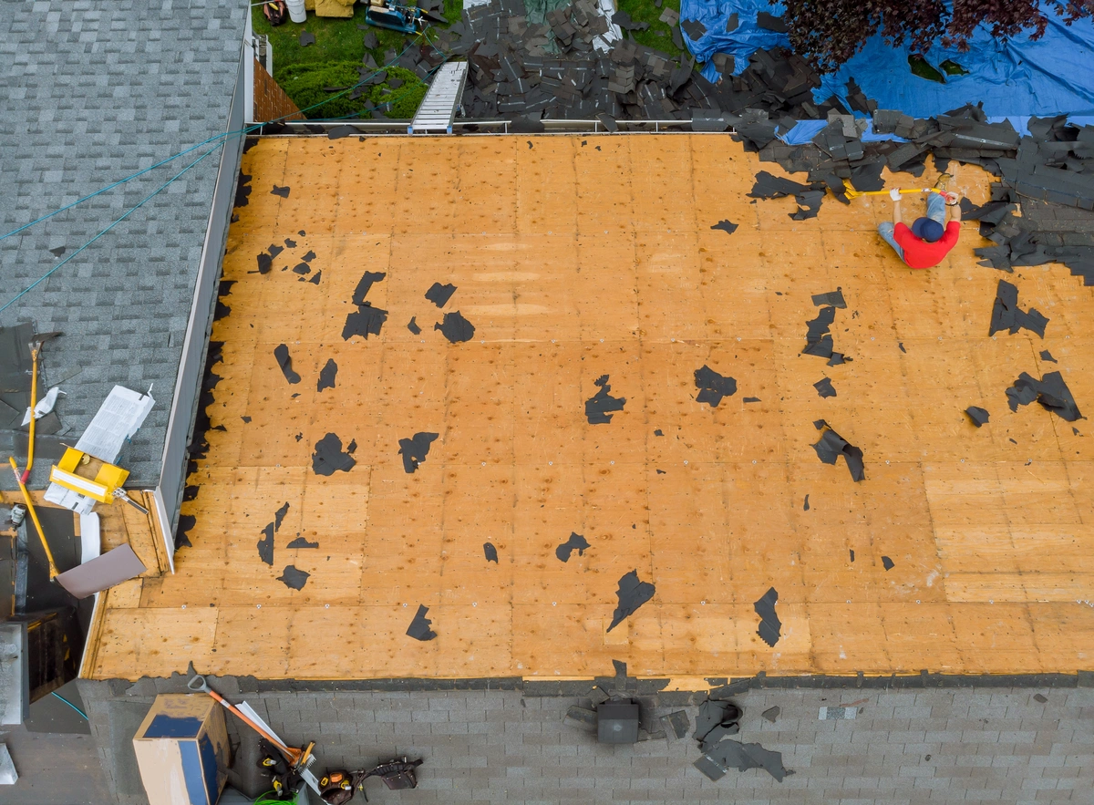 arial view of contractor removing roof shingles