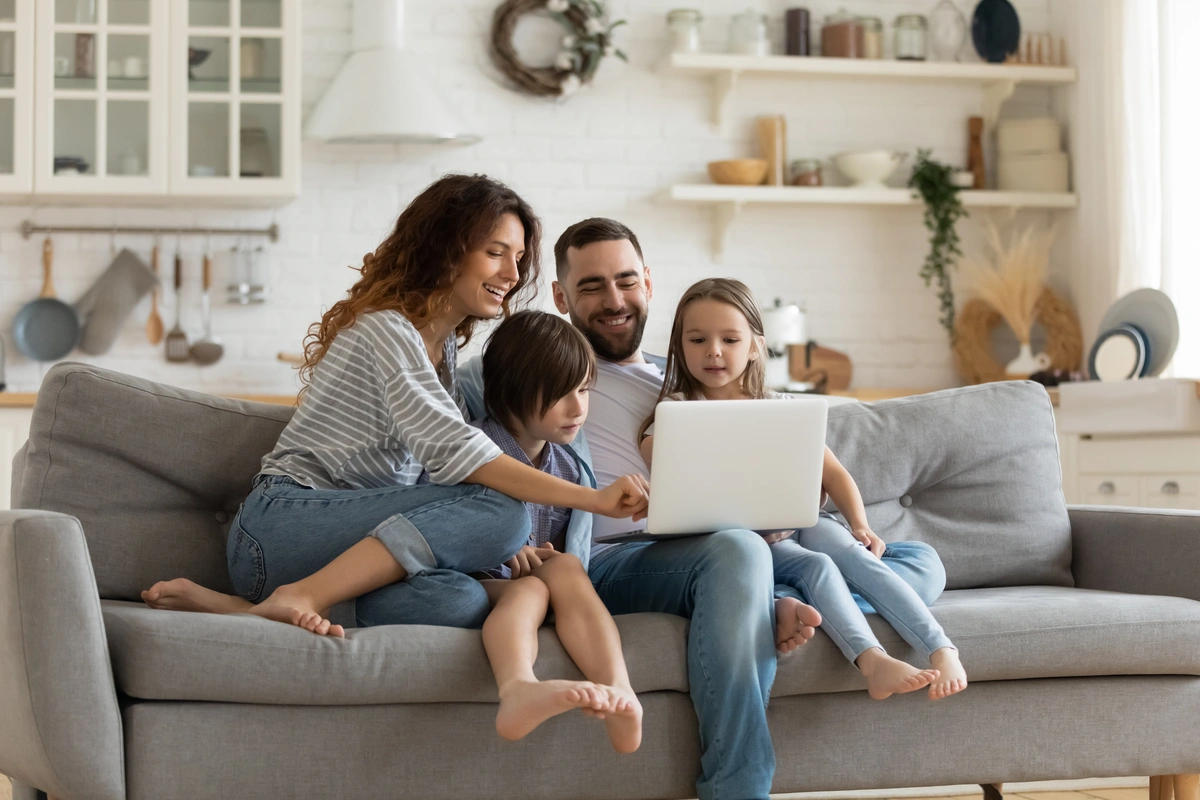 family researches new siding options on computer