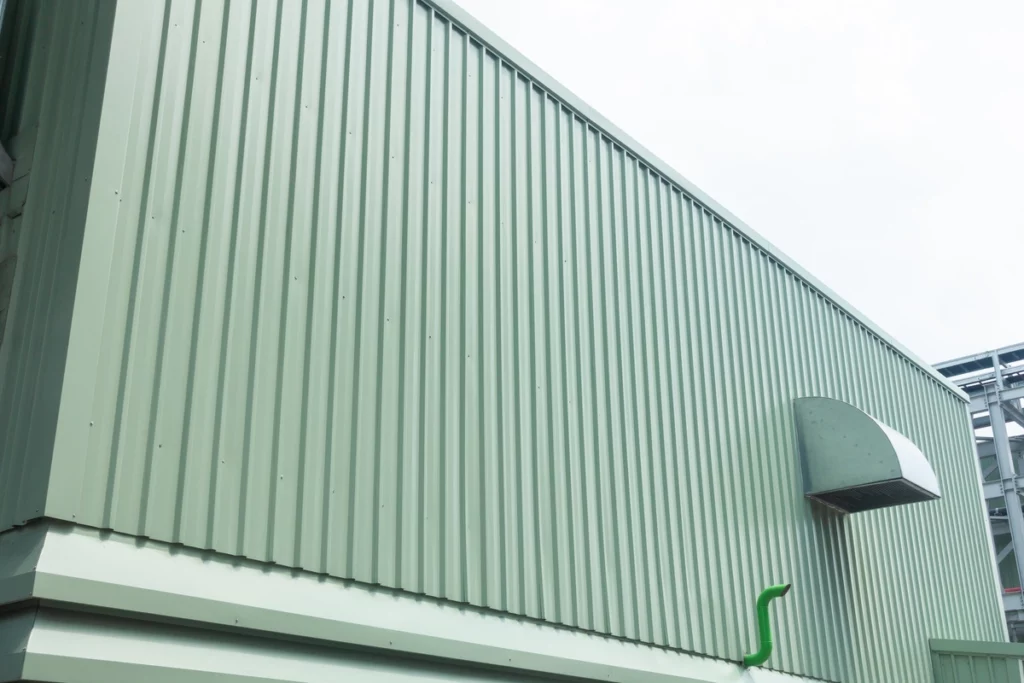 close up of green vertical types of metal siding