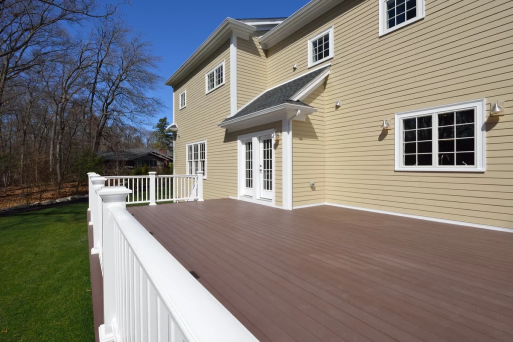 beige vinyl siding on residential home with deck