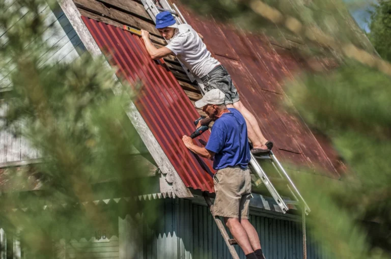 professional roofers repairing the roof of country house