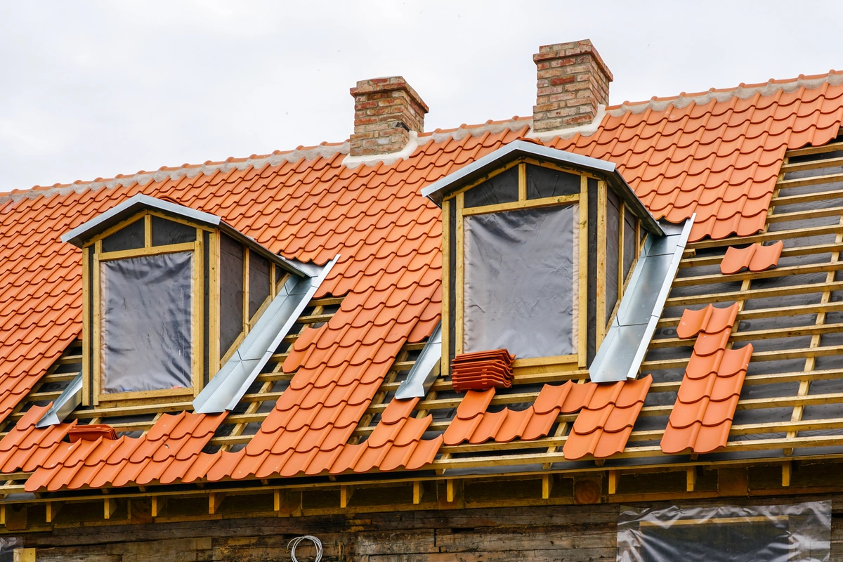 Roof renovation of a historical house with clay tiles