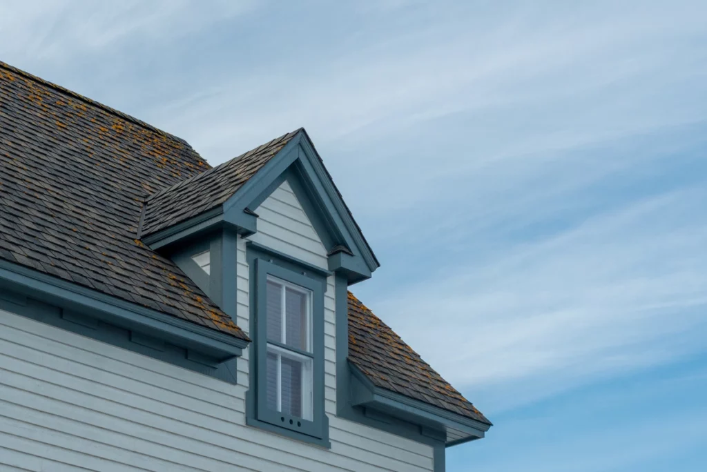 family house with aged and damaged roof shingles