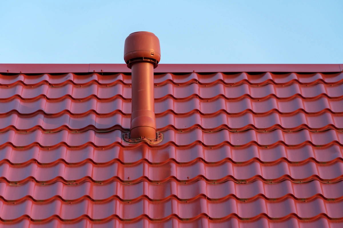 red metal roof with ventilation pipe