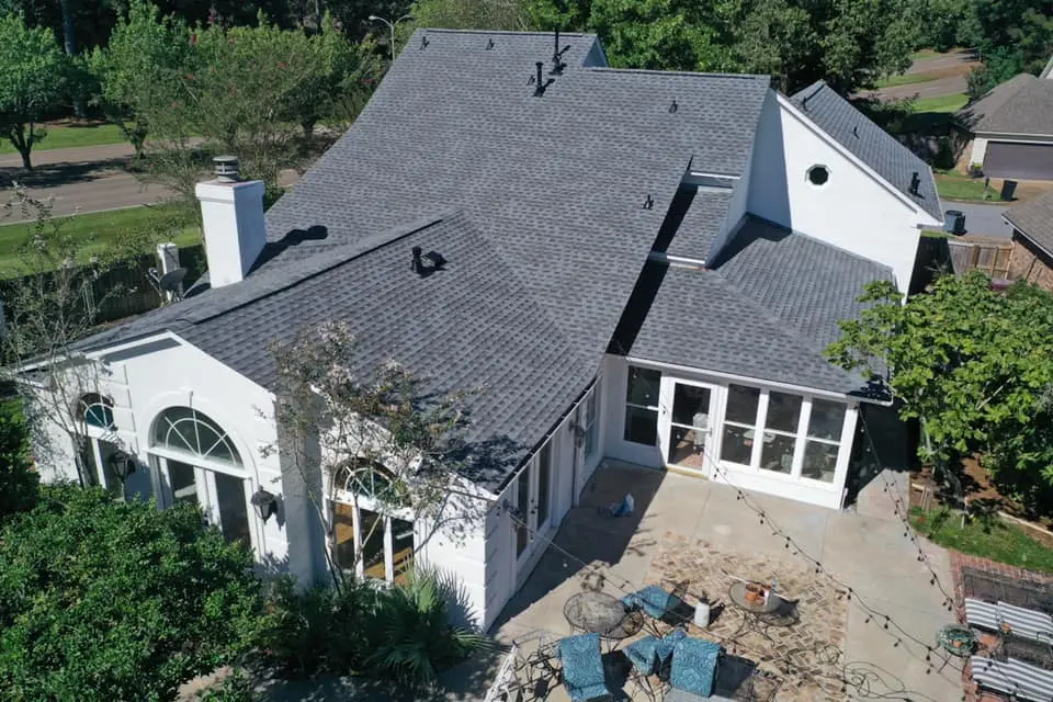 large house with repaired asphalt shingles
