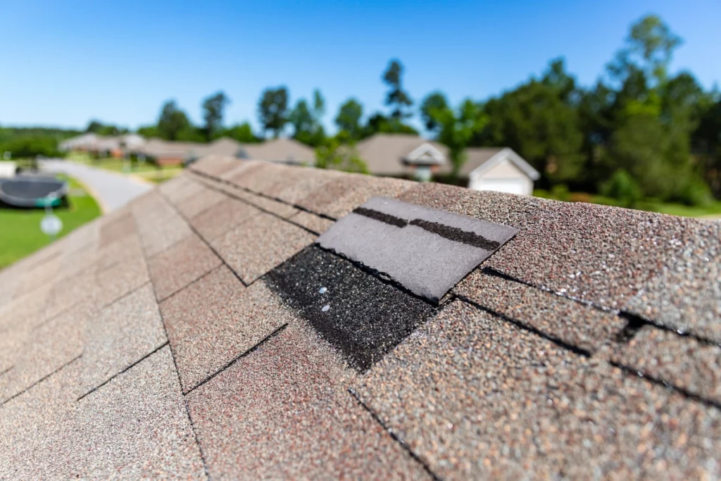 One shingle that is missing from an asphalt shingle roof
