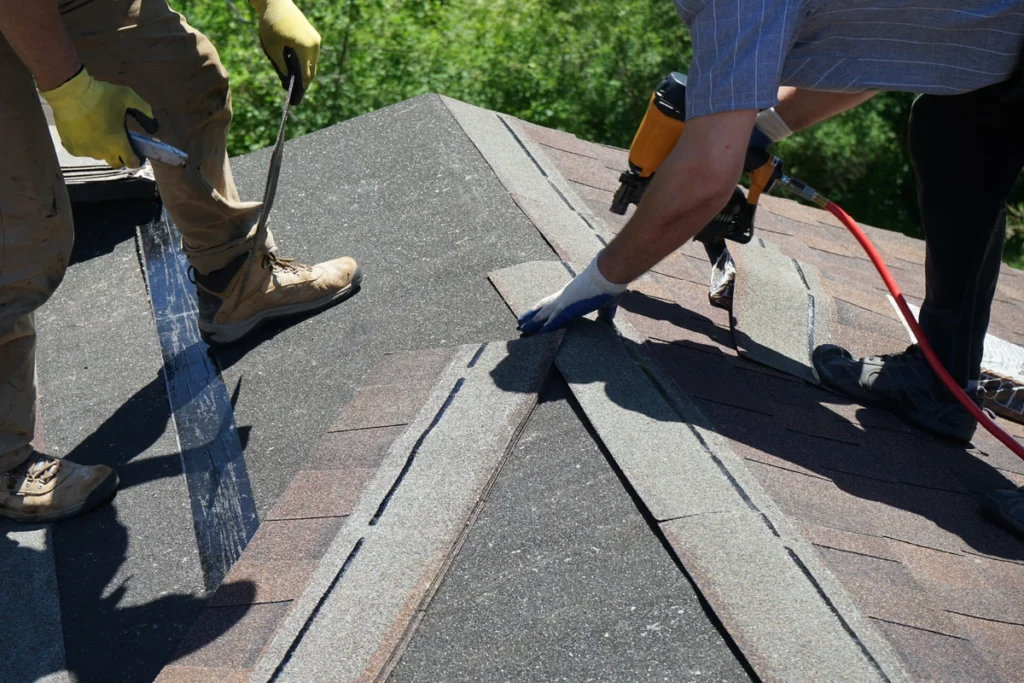 tear off roof- workers installing shingles