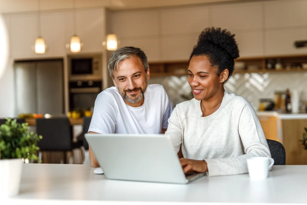 couple on computer looking up worthington roofing companies