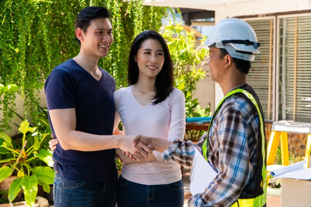 couple shaking hands with storm damage roofing contractor in upper arlington