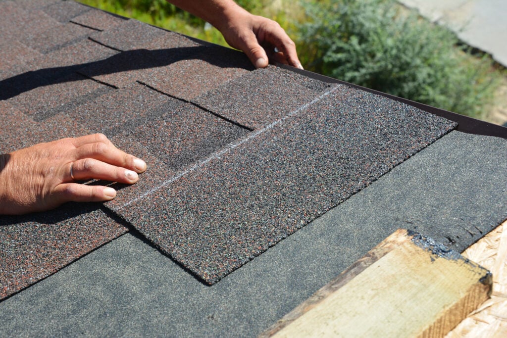 a man is installing shingles
