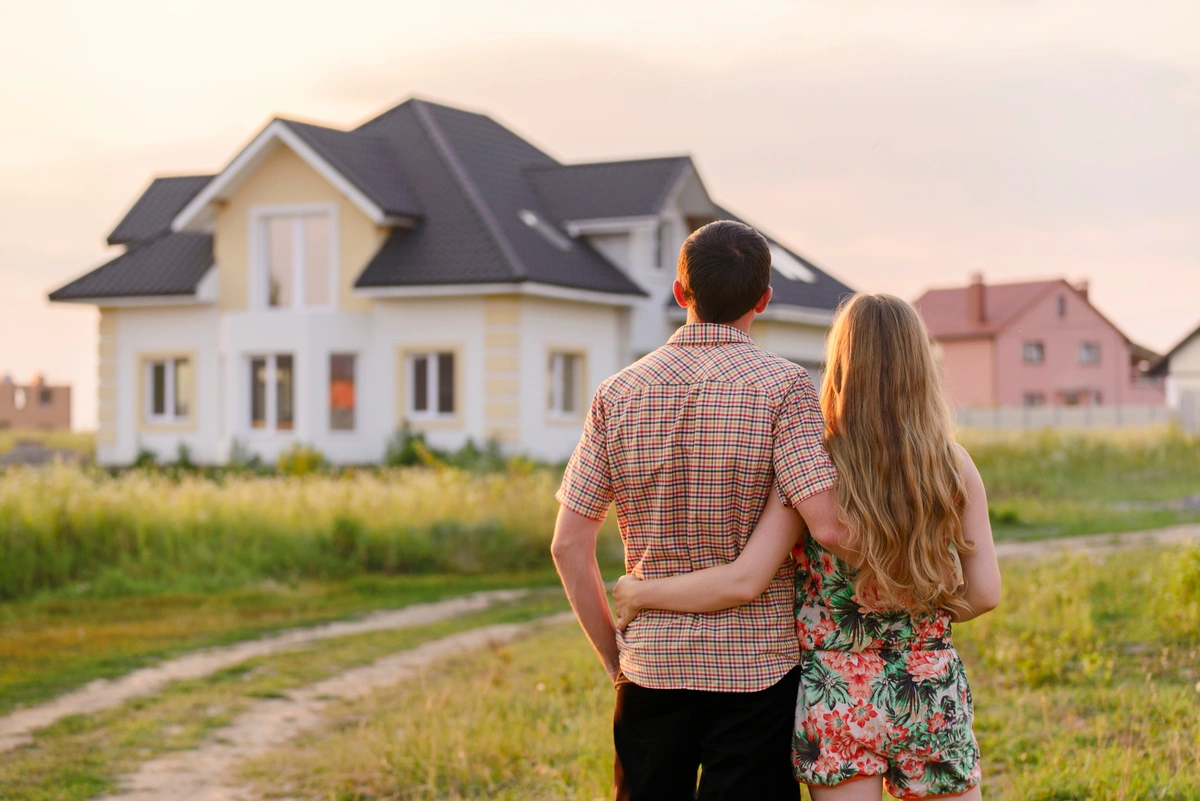 storm damage repair couple looking at their repaired house
