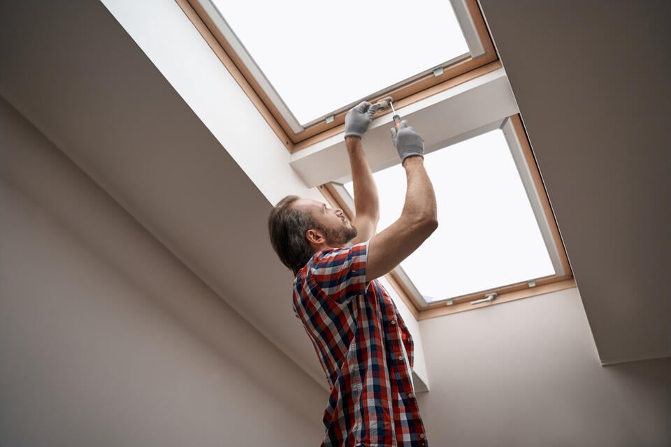 skylight repair-interior view of man repairing skylights