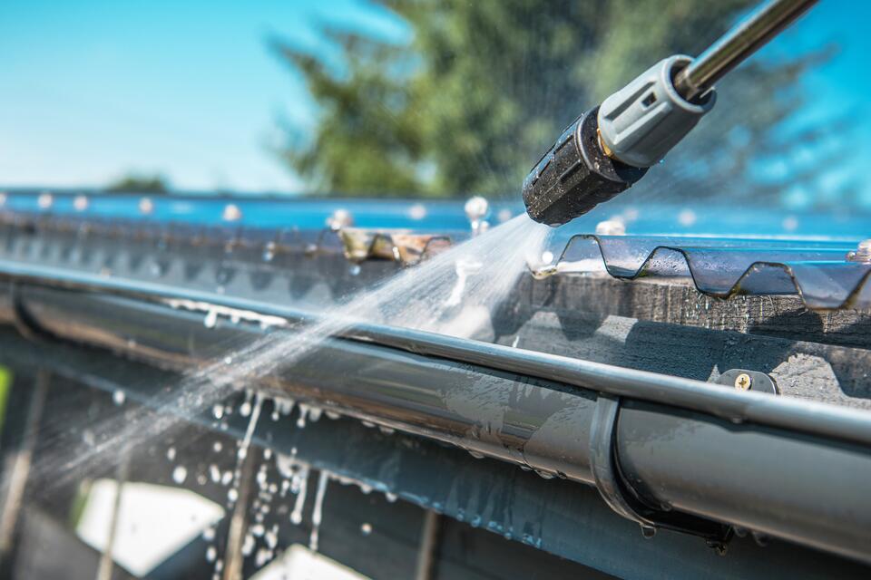 gutter cleaning-close up of gutters being power washed