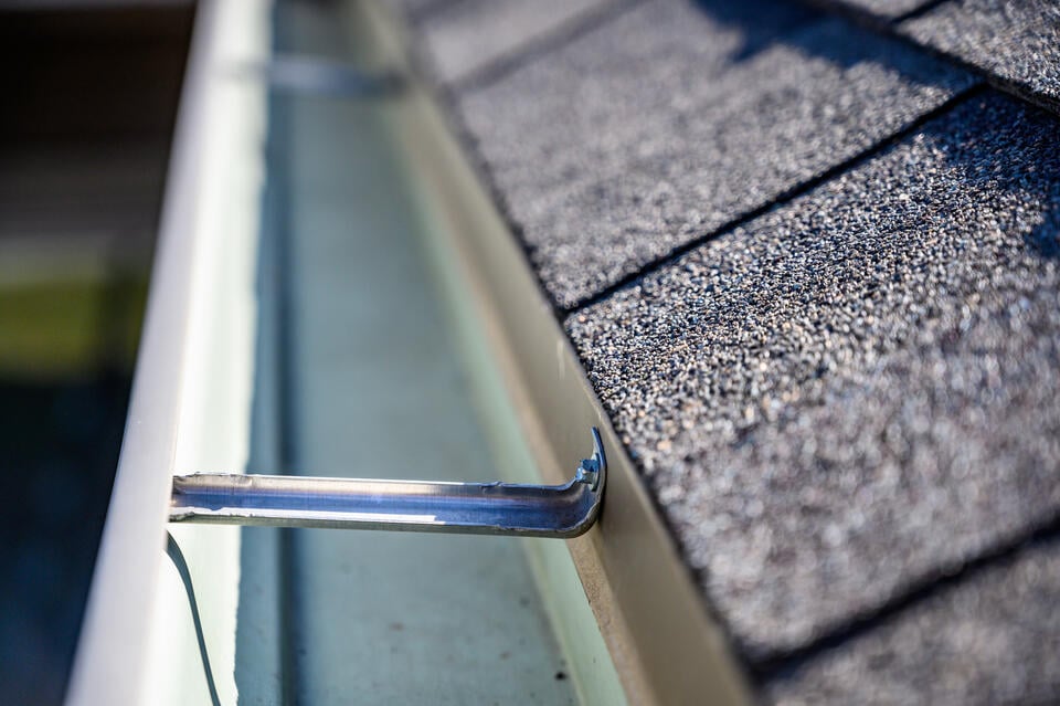 gutter cleaning-close up of recently cleaned gutters on a shingle roof