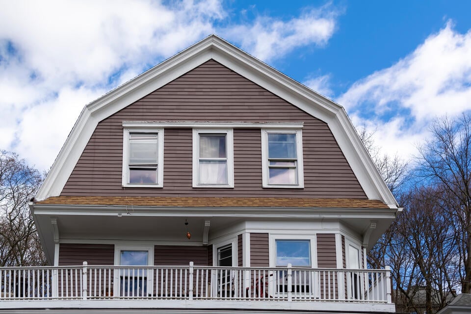 modern roof-brown sided house with a gambrel roof