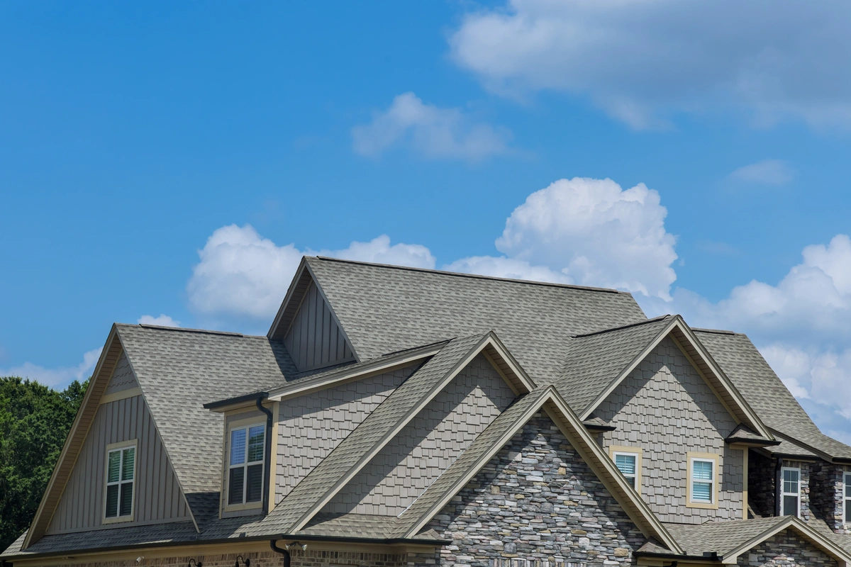 outside view of a home with stone exterior against a blue sky in Upper Arlington, OH