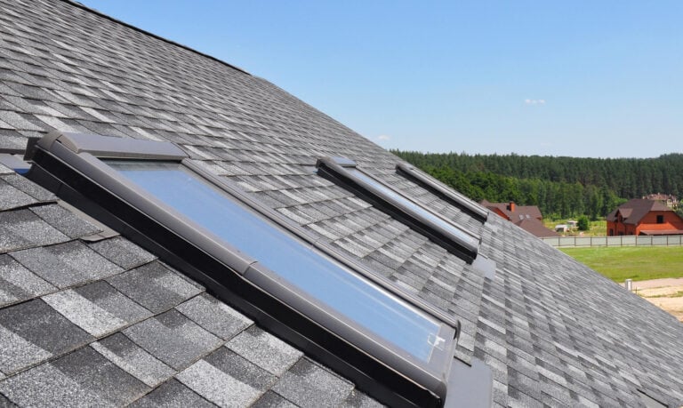 skylight flashing-close up of 3 skylights on a shingle roof