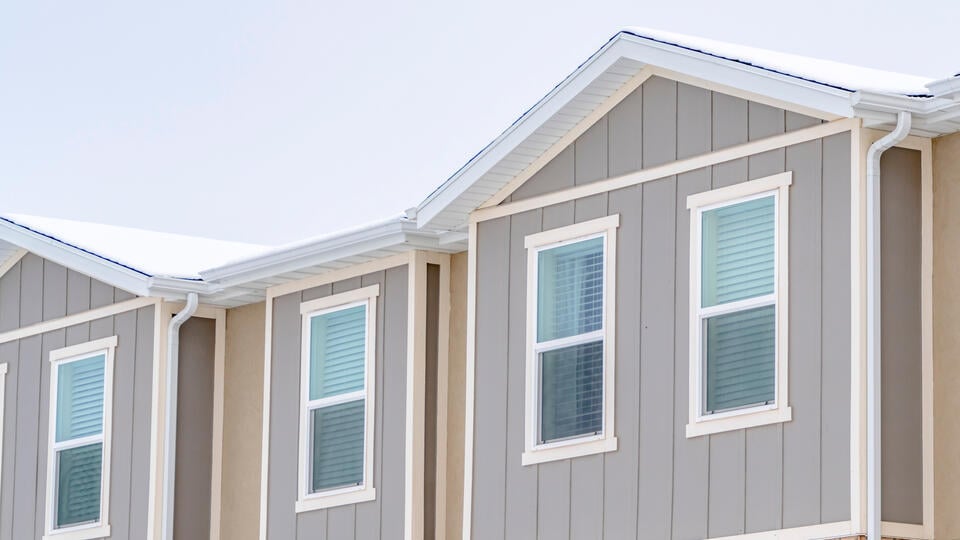 vertical siding-beige vertical siding on a home with white trim