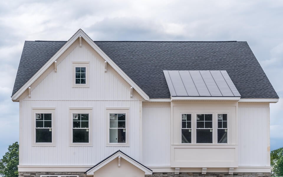 vertical siding-white shiplap vertical siding on a home with a shingle roof