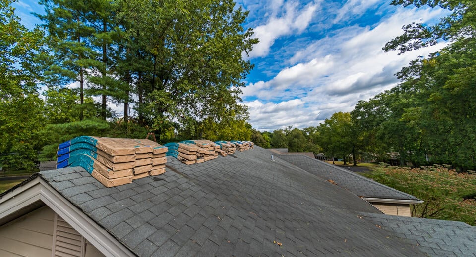 how many shingles in a bundle-bundles of shingles sitting on roof ridge prior to replacement