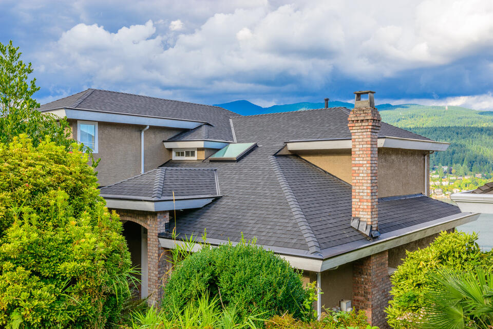 gray shingles house with mountains in background
