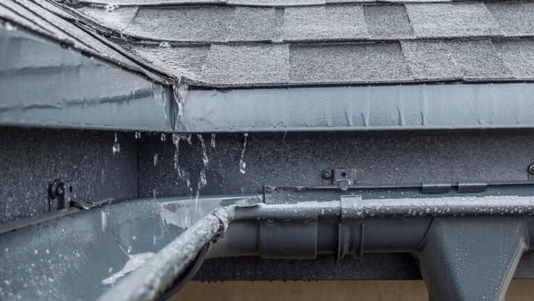roof drain-gutters catching rain runoff from roof