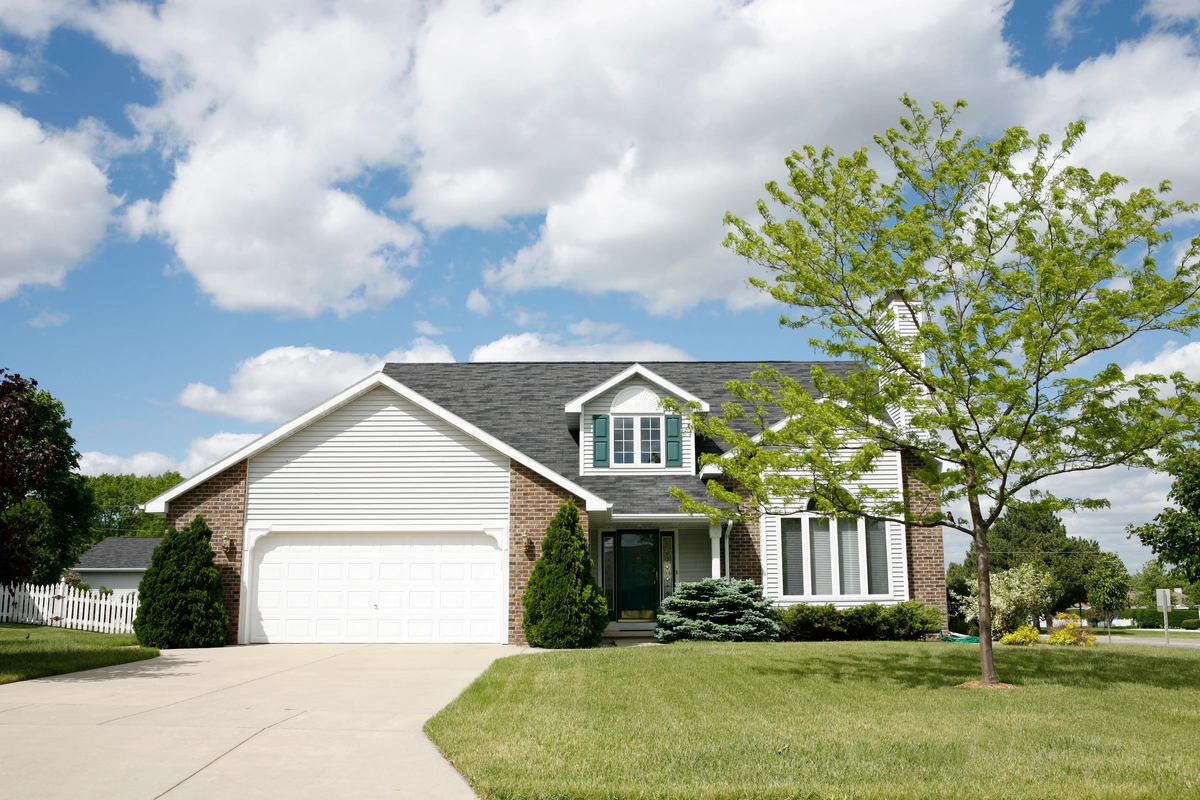 brick and vinyl siding large home
