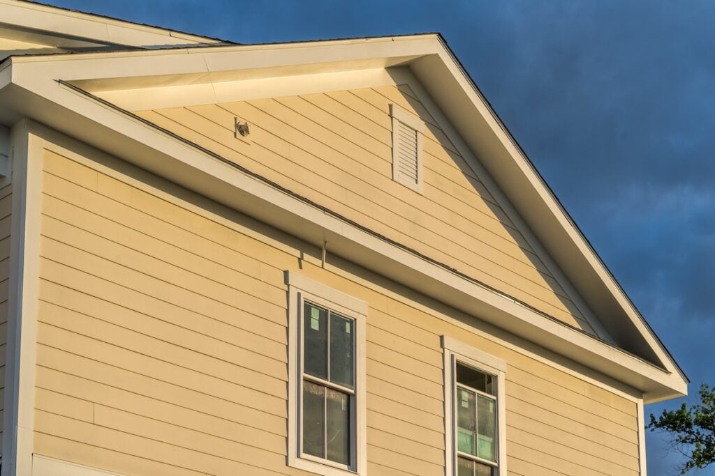 residential yellow house vinyl siding