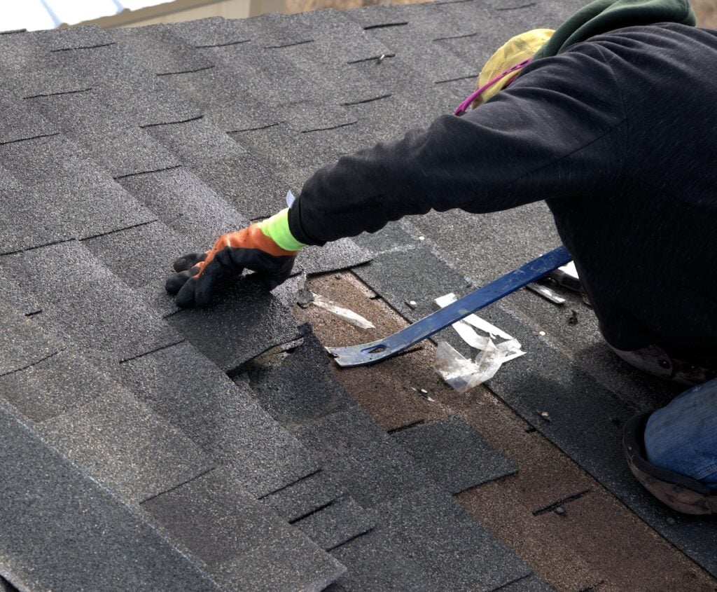 roofer repairing asphalt roof