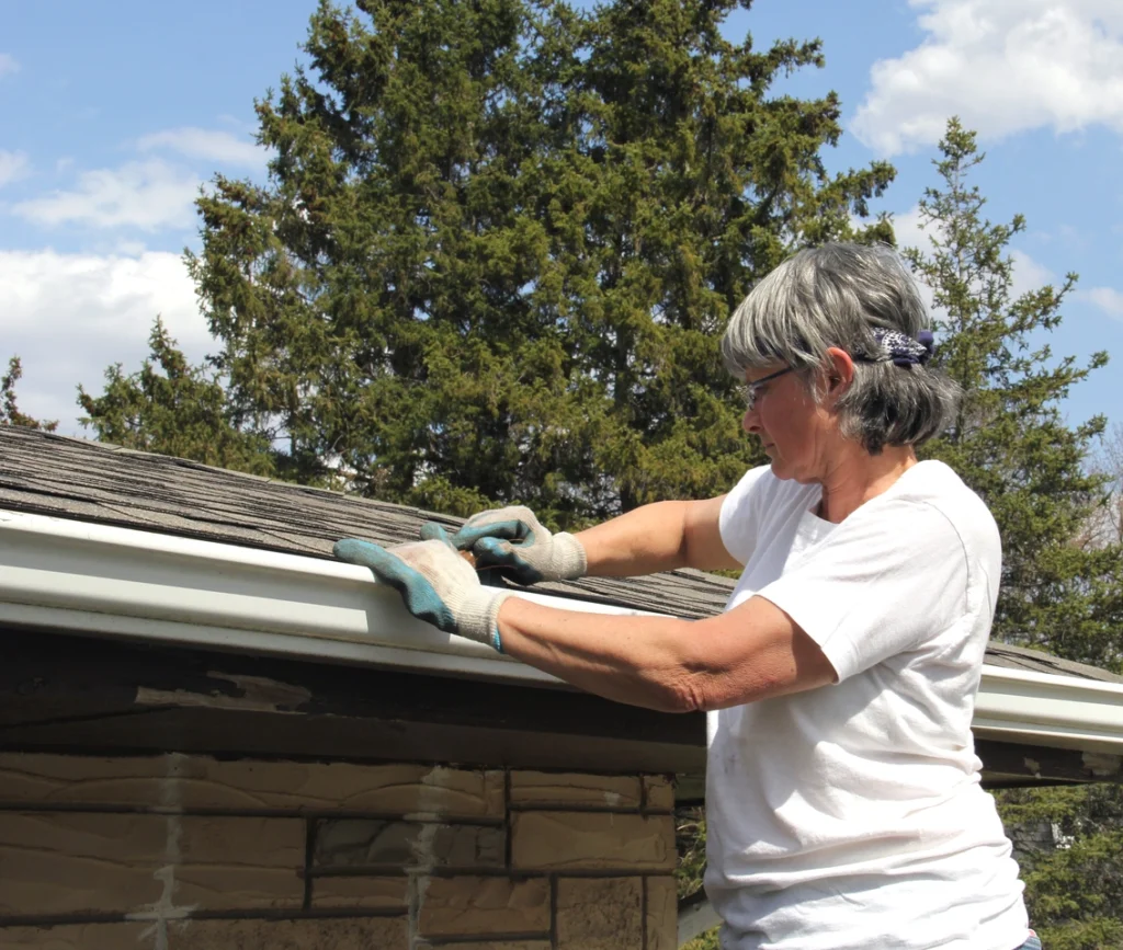 woman cleaning gutter tools