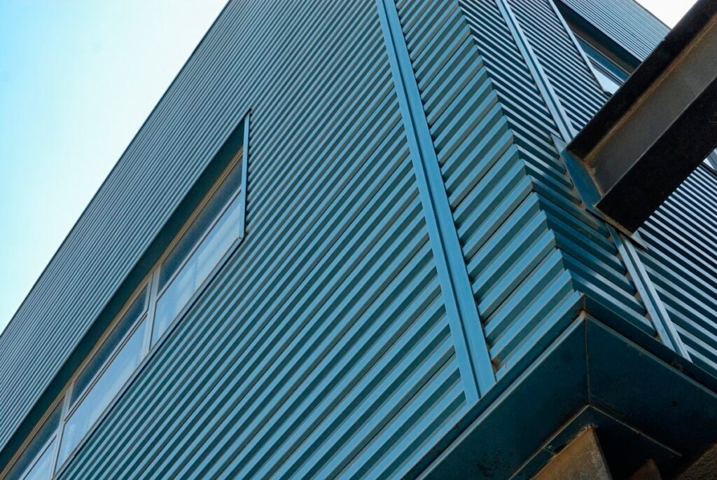 Blue metal exterior siding of a building.