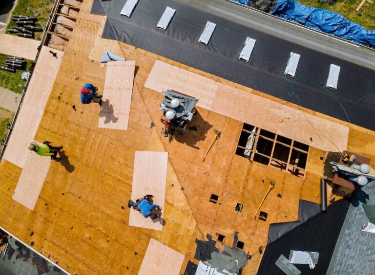 Removal of old roof replacement with new shingles of an apartment building