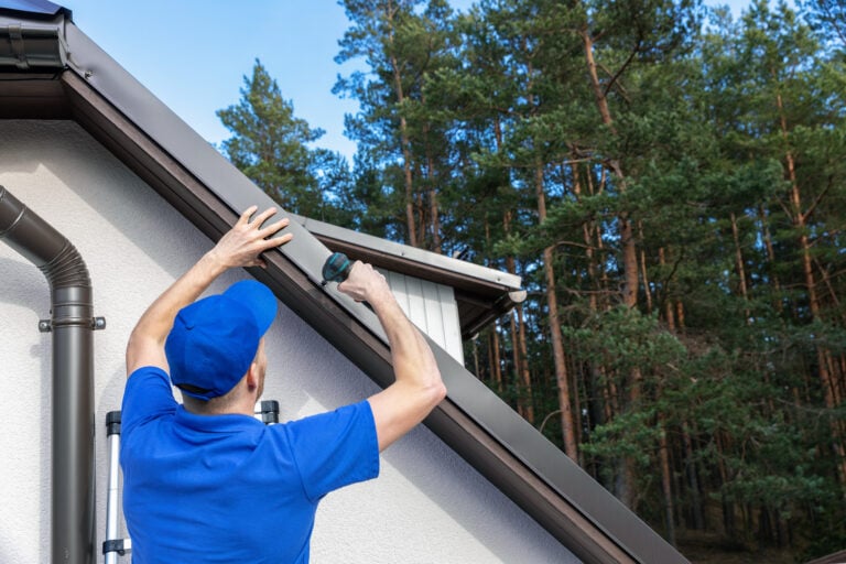 roofer installing metal drip edge profile on the house roof