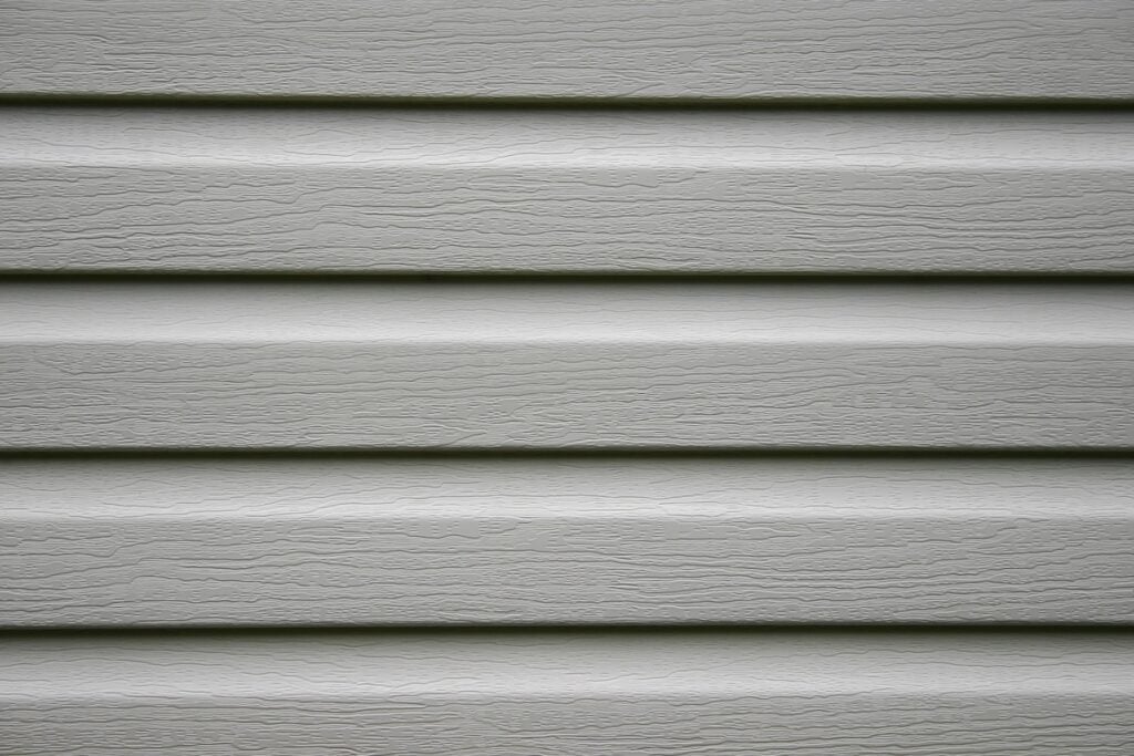 a fragment of a house wall trimmed with siding