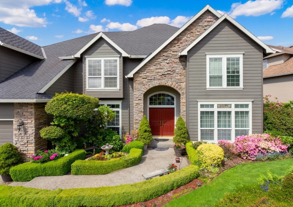 Beautiful New Home Exterior and Landscaping on Sunny Afternoon easiest siding to install