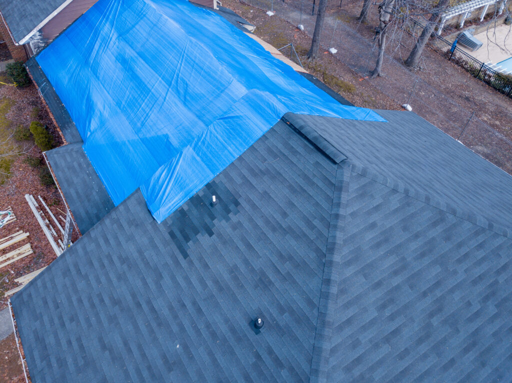 Fire damaged apartment building roof tarping cost